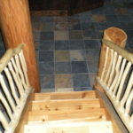 log stairway, railing, slate floor