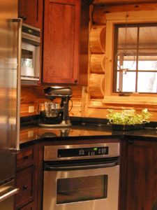 Kitchen area, range, cedar log home