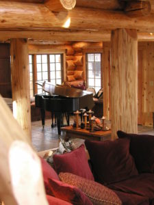 Looking accros the log home at the piano room