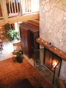 Looking down from loft at fireplace and great room