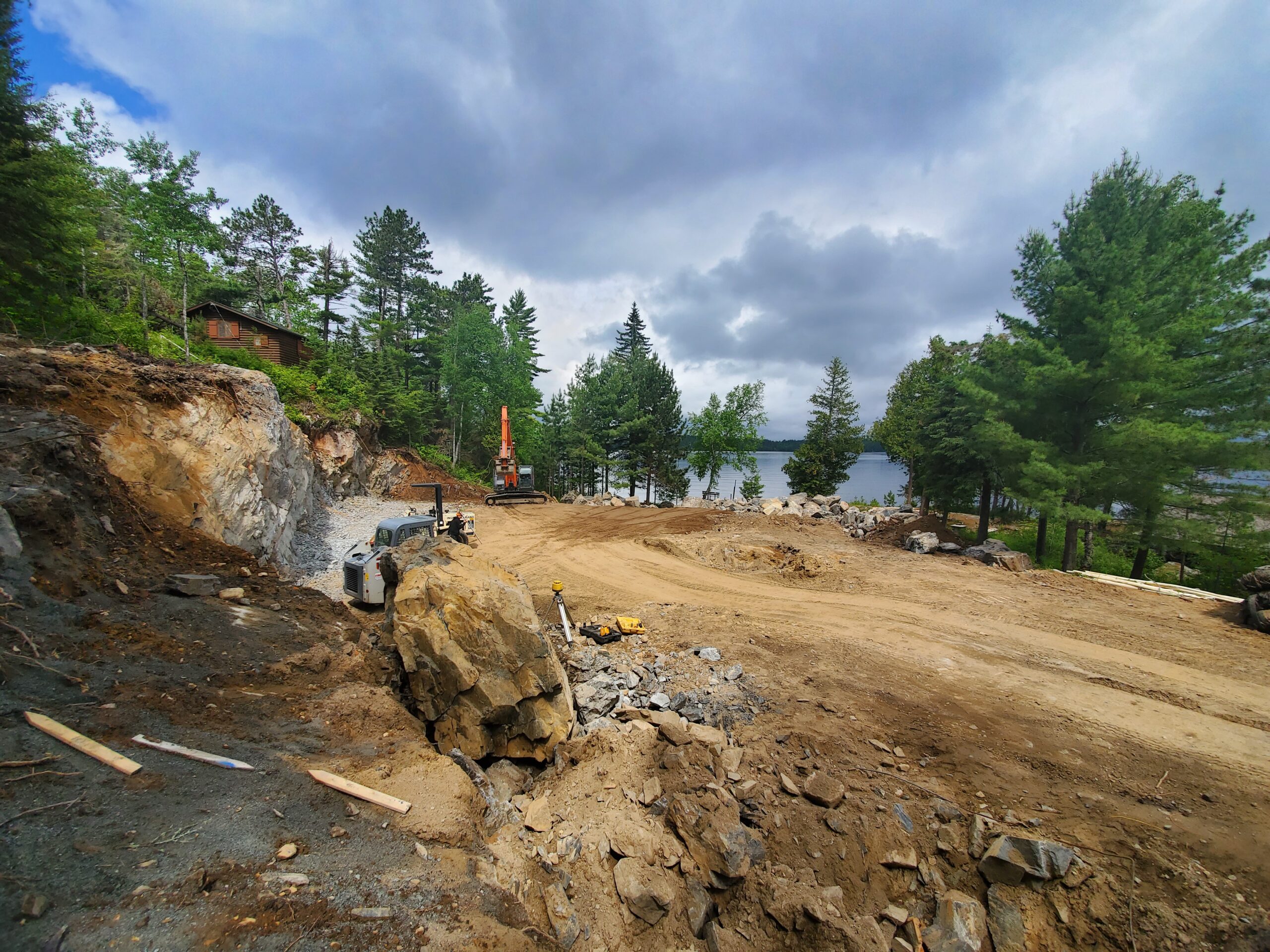 Blasting rock for new custom lake home by Huisman Concepts Blasting rock for new custom lake home by Huisman Concepts