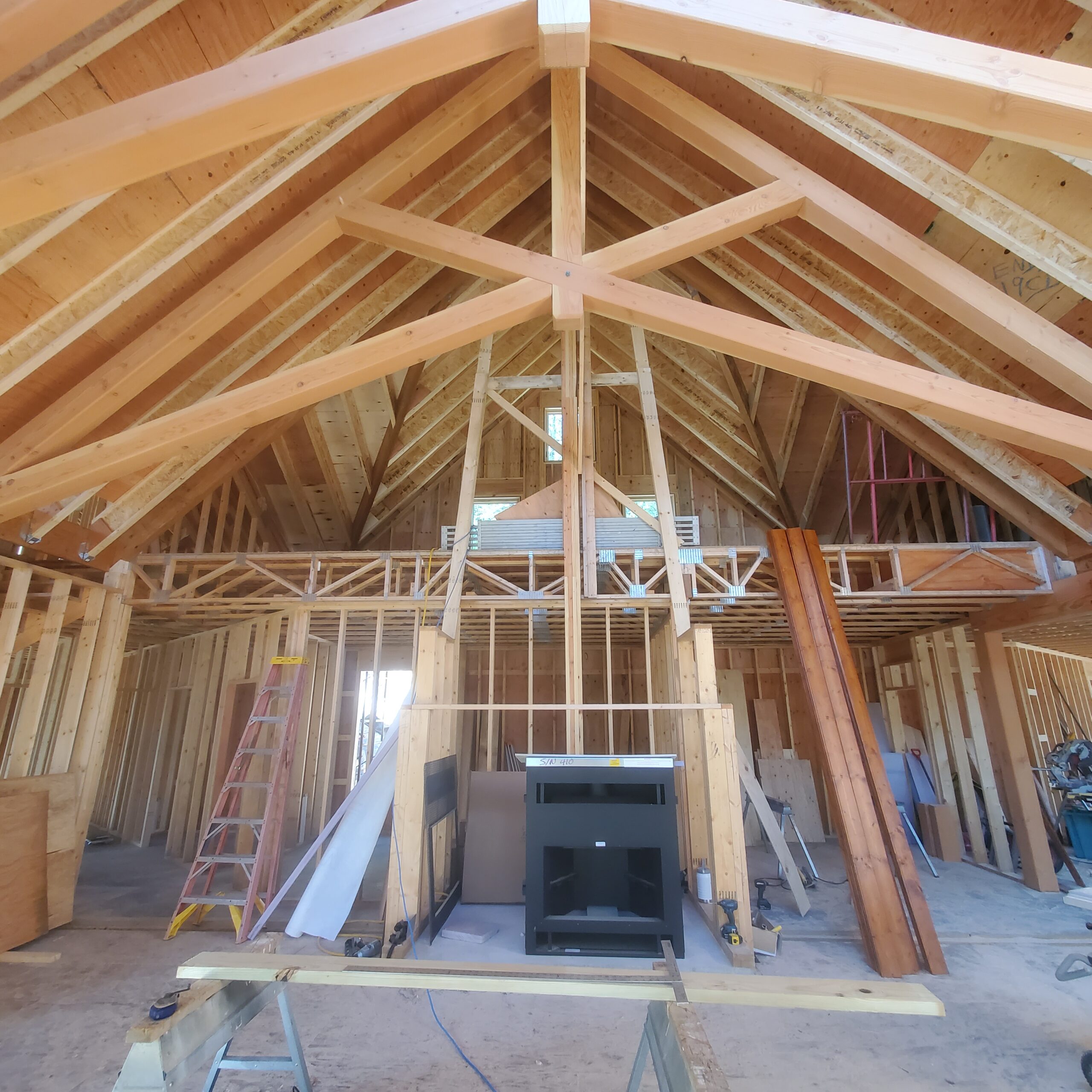 Timber trusses and start of fireplace Timber trusses in the great room